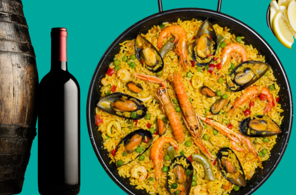 a bottle of wine near barrel with spanish seafood paella