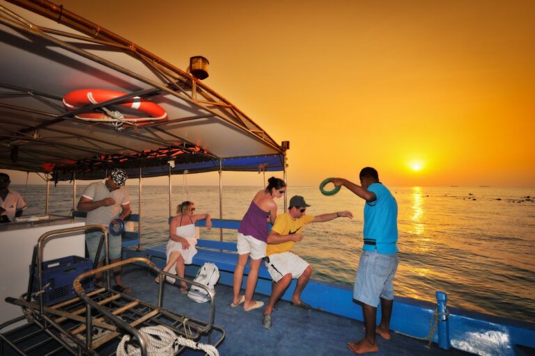 A group of friends traveling in the Maldives by boat and having a great time.